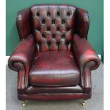 Thomas Lloyd; a 20th century red leather upholstered button back easy armchair,