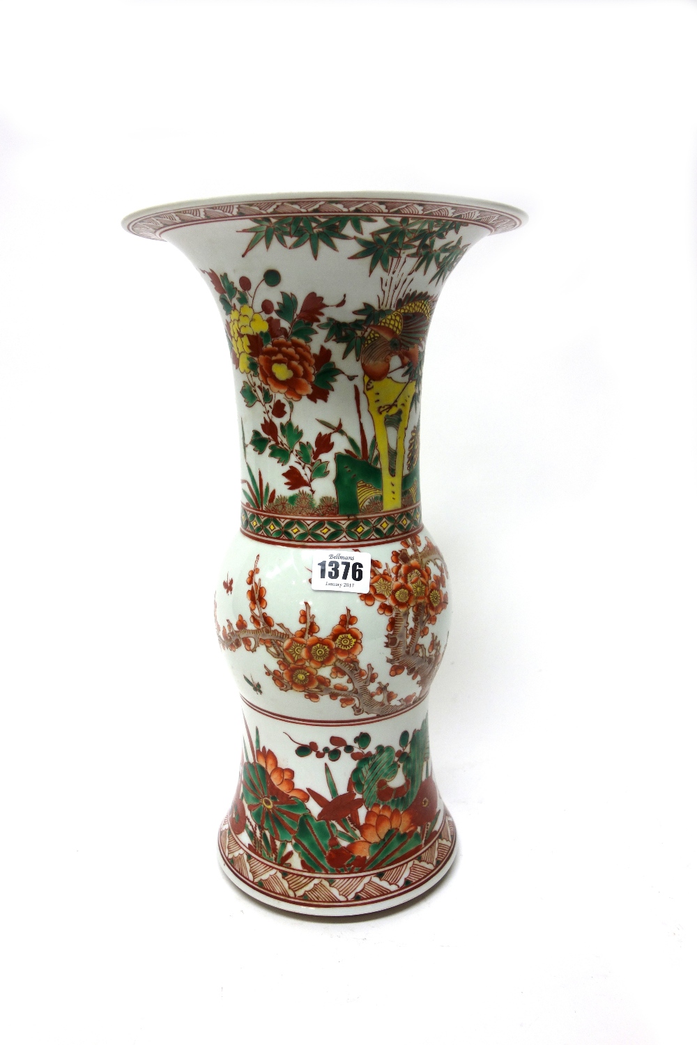 A Chinese beaker vase (gu), painted in a famille-verte palette with birds amongst flowering shrubs,