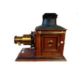 An Edwardian mahogany cased magic lantern 'Optimus' by Perken Son & Co Ltd and a quantity of slides.