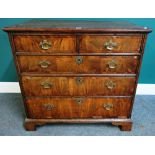 A mid 18th century oak and walnut chest of two short and three long graduated drawers on bracket