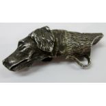 A cast silver whistle, modelled as a dog's head, otherwise with a bark textured finish, modern,