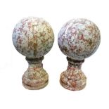 A pair of modern terracotta pier finials, each of turned spherical form,