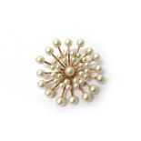 A gold and cultured pearl brooch, in a radiating circular design,