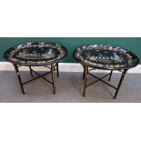 A pair of Victorian mother-of-pearl parcel gilt oval black lacquer trays on later stands, 67cm wide.