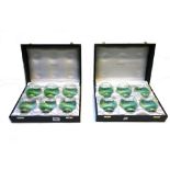 Two cased sets of six Bvlgari brandy glasses, each of green glass globular form,