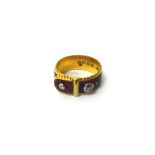 A 22ct gold, red enamelled and diamond set ring, in a buckle and strap design,