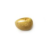 A gold ring, of bombe form, having a textured finish, ring size S, weight 9.8 gms, with a case.