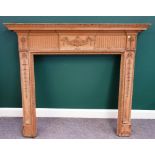 An 18th century Adam style pine fire surround, with carved decoration, 155cm wide x 134cm high,