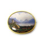 A gold mounted, Swiss enamelled oval brooch, depicting an alpine scene,