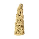 A Japanese ivory okimono, Meiji period, carved as a tower of figures,