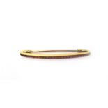 A French gold and ruby set brooch, in a curved design,