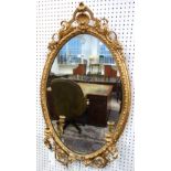 A Victorian gilt framed oval twin branch mirror with pierced frame, 68cm wide x 118cm high.