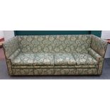 A 20th century Knole sofa in studded patterned green upholstery, 250cm wide x 82cm high,