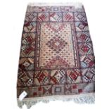 An Indian part silk rug, the field with stylized diamond design, complementary section border,