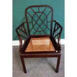 A mahogany cockpen armchair, circa 1900, on canted block supports, 63cm wide x 95cm high.