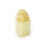 A small Chinese white jade seal, 19th century,of square section,the top surmounted by a chilong,