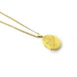 A 9ct gold oval pendant locket, the front with feathered scroll engraved decoration,