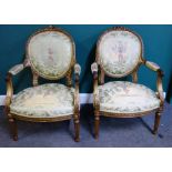 A pair of Louis XVI style gilt wood fauteuils, on tapering fluted supports,