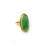 A gold ring, mounted with an oval jade, detailed 750, ring size V.