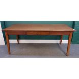 An 19th century French oak kitchen table, the plank top with single frieze drawer,