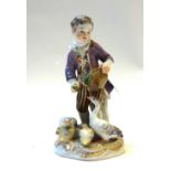 A Meissen porcelain figure, early 20th century, modelled as a young boy feeding ducks,