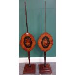 A pair of made up 19th century mahogany pole screens, with shaped marquetry panels, 130cm high.