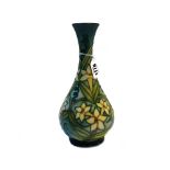 A Moorcroft pottery vase, circa 1990, decorated with yellow flowers against a mottled green ground,