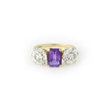 A gold and platinum, diamond and amethyst three stone ring,