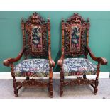 A pair of Victorian carved oak open armchairs, on block and turned supports, 73cm wide x 133cm high.