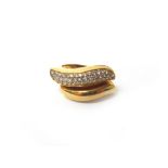 A gold and diamond set ring, in a twist and curved design,