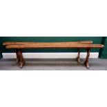 A pair of 19th century French fruitwood benches on trestle ends, each 200cm wide x 48cm high (2).