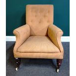 A Victorian easy armchair on turned mahogany supports, 92cm high x 69cm wide.