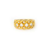 A gold and diamond ring, in an interwoven design,
