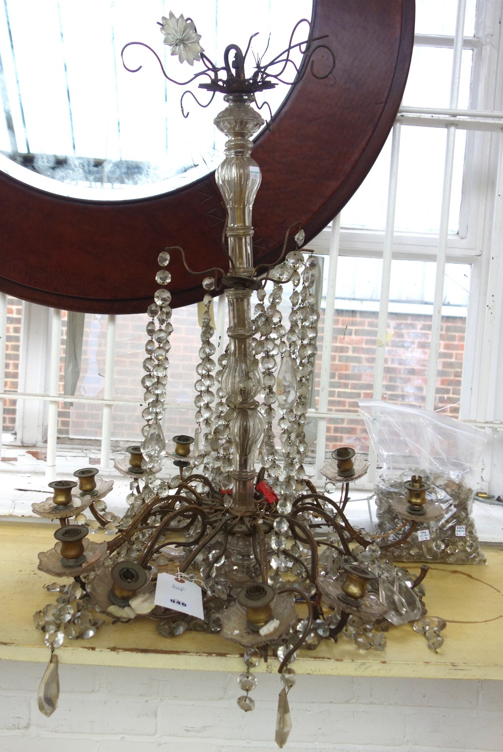 An ormolu twelve light chandelier, early 20th century, with cut crystal festoons and drops, (a.f.