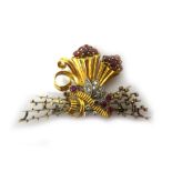 An 18ct gold, ruby and diamond brooch, in a twin cornucopia and foliate design,
