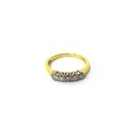 An 18ct gold and diamond five stone ring, claw set with a row of circular cut diamonds, ring size K,