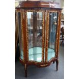 A late 19th/early 20th century gilt metal mounted kingwood serpentine two door vitrine,
