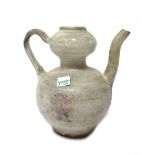 A Chinese spouted ewer, possibly Yuan dynasty, covered in a white glaze with purple splashes, 16.