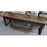 A 19th century refectory table, with graffitied metal bound twin plank top on canted supports,