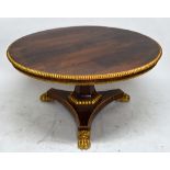 A Regency parcel gilt rosewood circular snap top breakfast table with split bobbin moulded edge,