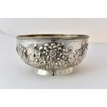 A Chinese silver bowl, of circular form, the body decorated with irises, on a circular foot,