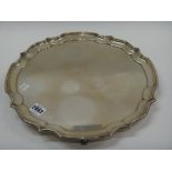 A silver salver of shaped circular form, with a pie-crust rim, presentation inscribed to the centre,