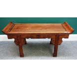 A late 19th century Chinese low hardwood carved altar table, on block supports,