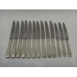 Ten table knives, having silver handles and steel blades,