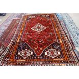 A Ghasghai rug, South Persian, the madder field with a stepped diamond, hooked cross spandrels,