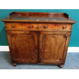 A Regency ebony strung mahogany side cabinet, with a pair of drawers over cupboards,