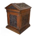 A Victorian carved walnut box of architectural form, with lifting roof over doors,
