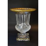 A Saint Louis Crystal urn shaped vase, with hobnail decoration and gilded rim upon a square base,
