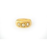 A gold and diamond set three stone ring,