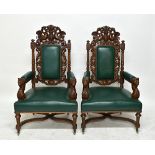 A pair of late 19th century Renaissance Revival carved oak large armchairs, 131cm high x 77cm wide.